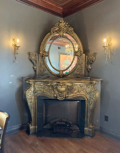 Ornate fireplace in dining room of restaurant.
